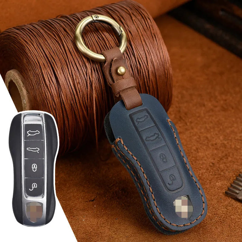 Brown leather Porsche key case with retro bag buckle holding three car keys