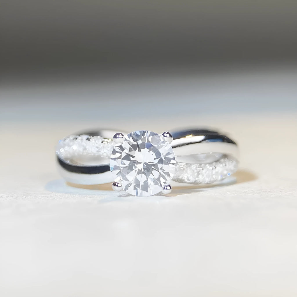 Geometric twisted arm silver ring with 1 karat moissanite centre stone in four-claw setting