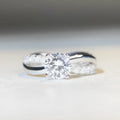Geometric twisted arm silver ring with 1 karat moissanite centre stone in four-claw setting