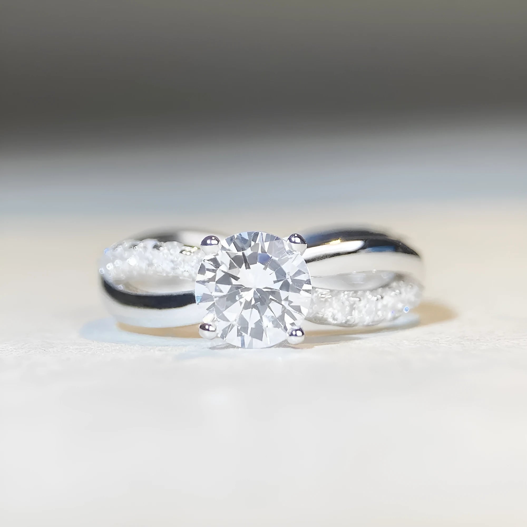 Geometric twisted arm silver ring with 1 karat moissanite centre stone in four-claw setting