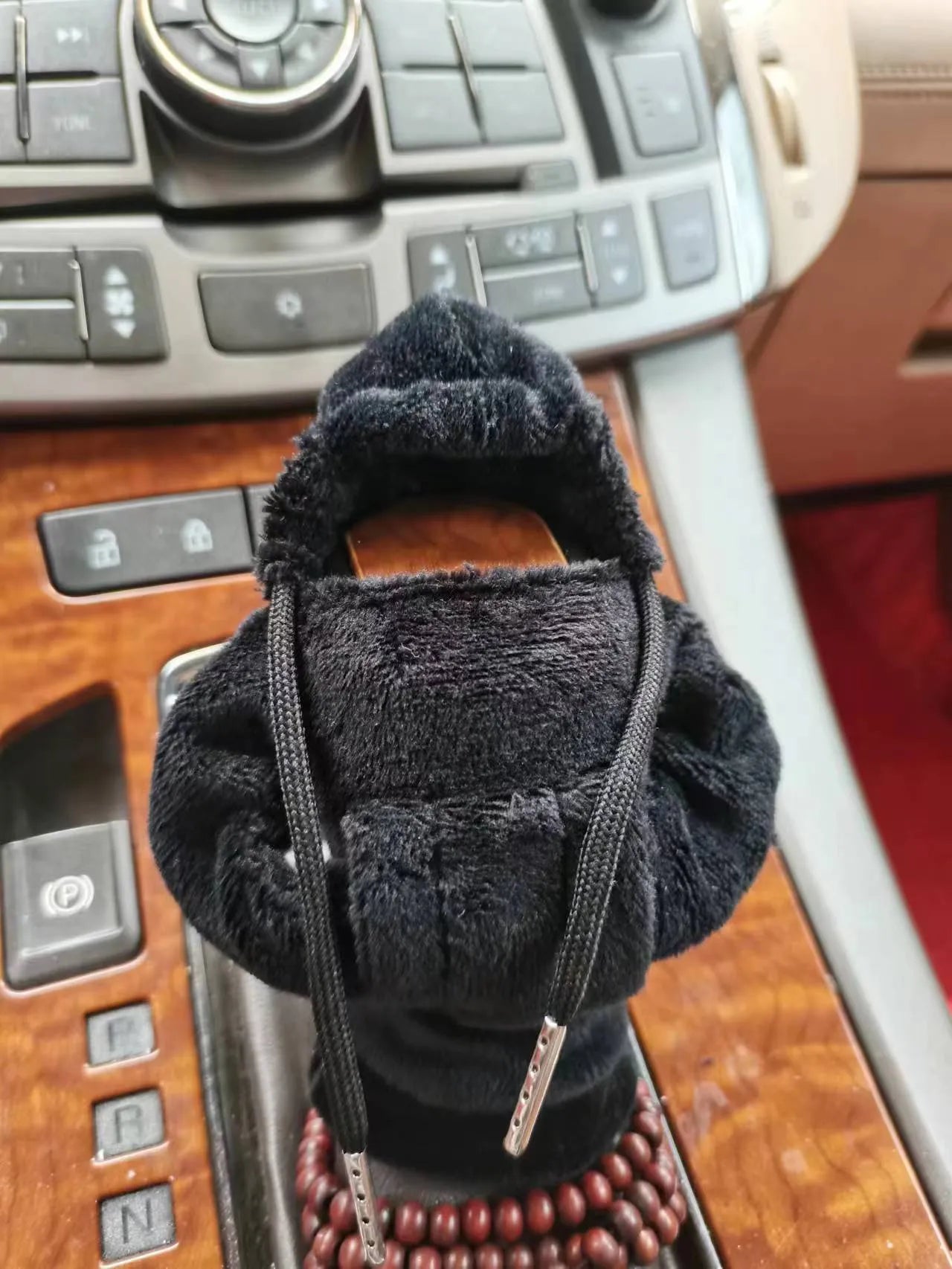 Dutch velvet car gear handle sleeve cover in multiple colours on a car gear lever.