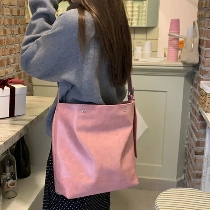 Corduroy tote bag with one-shoulder strap in pink colour showing structured dimensions and PU-lined interior