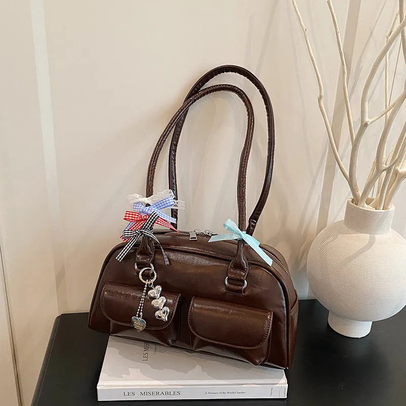 Retro pillow-shaped women's handbag in PU leather with double shoulder strap, shown in black colour