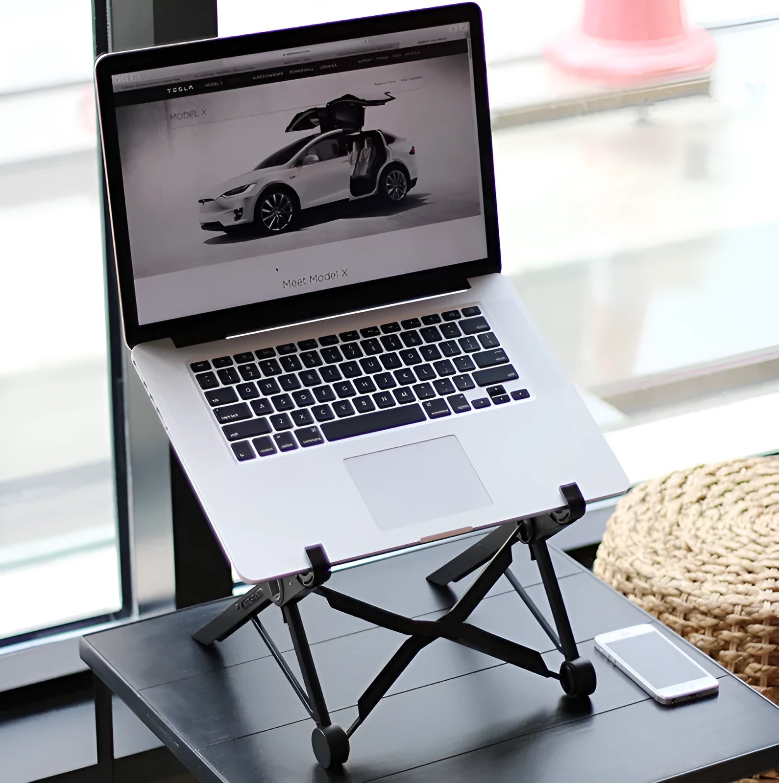 Black reinforced nylon portable folding laptop stand with 35.4cm width, shown in folded position.