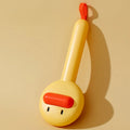 Small yellow plastic duck-shaped pet grooming comb with needle bristles.