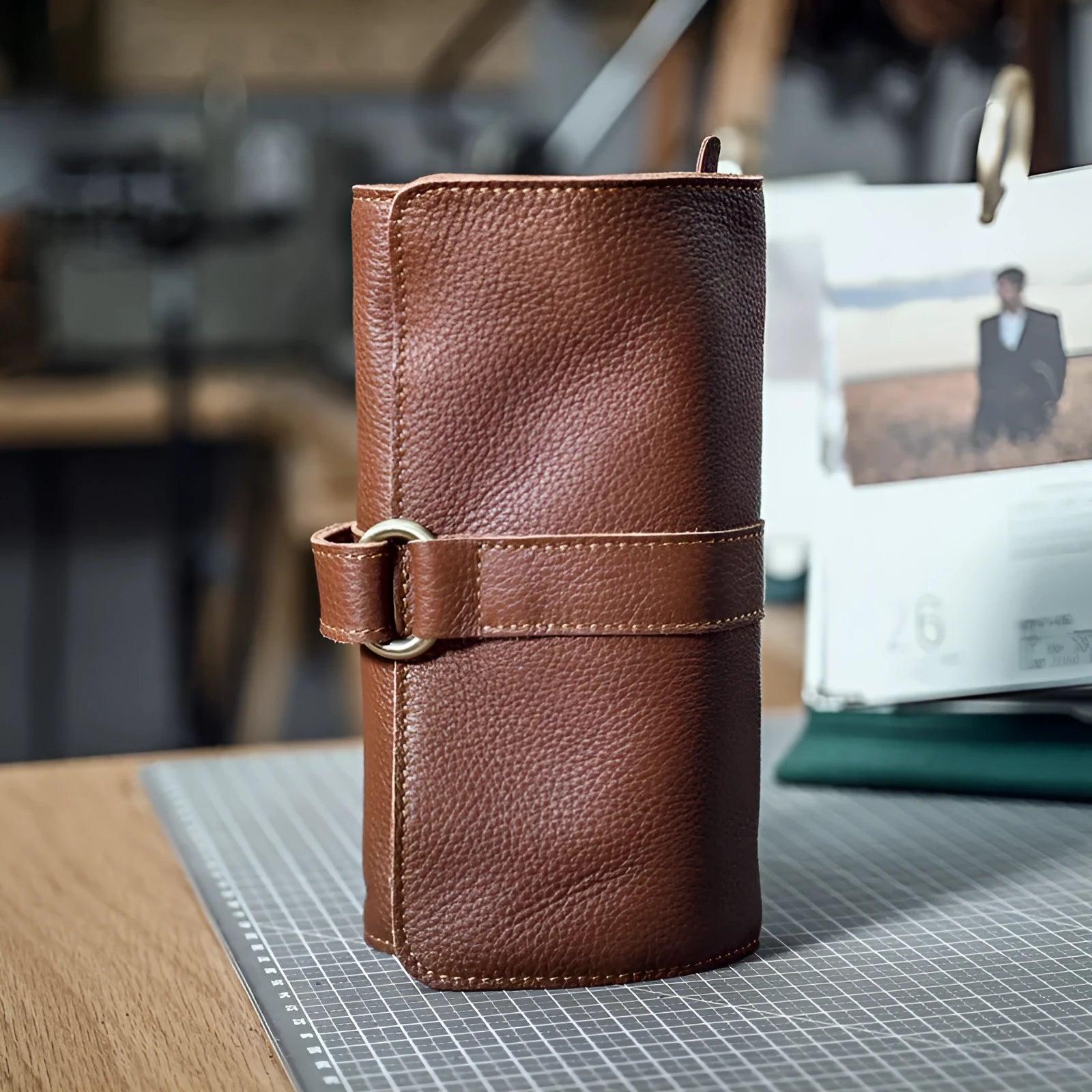 Handmade brown cow leather vintage wallet with tape closure, lying flat.