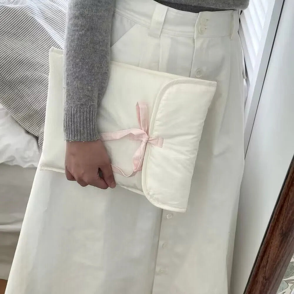 Black and white quilted women's laptop bag with a ballet bow and striped pattern.