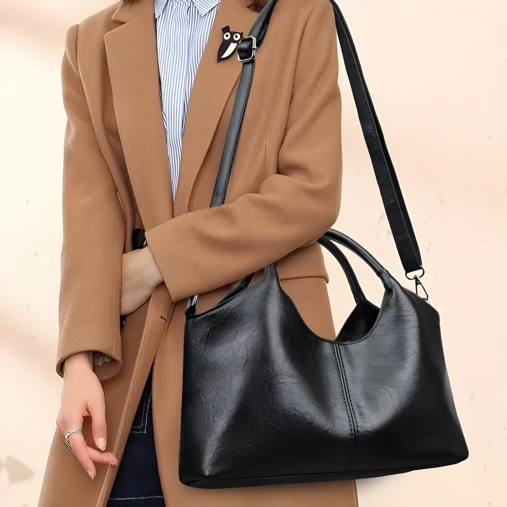 Women's genuine leather crossbody bag in beige colour showing soft construction and large capacity