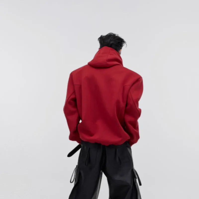 Men's loose fit red hooded sweater with raised three-dimensional printing on the front.