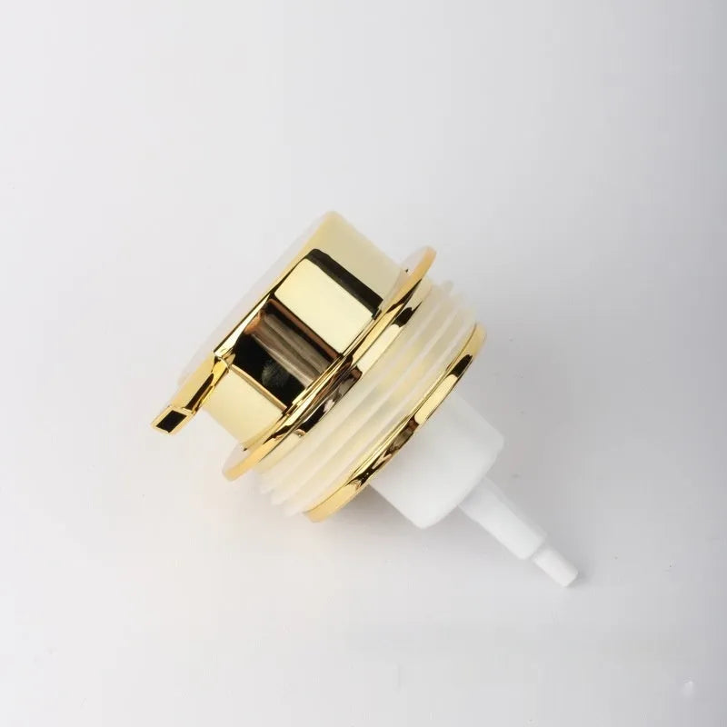 Large plastic foam pump dispenser for facial cleansers in a metallic gold finish