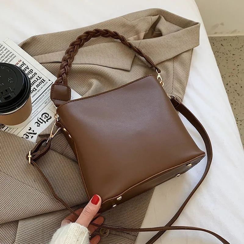 Retro khaki woven PU leather one-shoulder crossbody underarm bucket bag.
