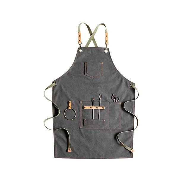 Canvas cross strap apron in camel colour shown from the front.