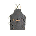 Canvas cross strap apron in camel colour shown from the front.