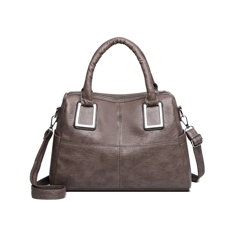 Women's square shoulder bag showing internal phone pocket and document compartment in neutral colour