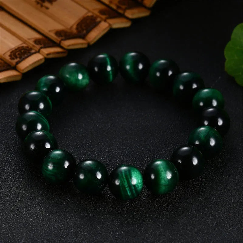 Green Tiger Eye stone beaded bracelet showing polished geometric beads on a wrist.