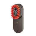 Compact pink smart massage comb with red light therapy for hair care