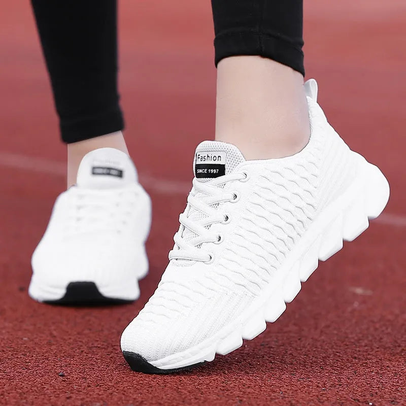 Women's running shoes with fly weave upper in Black, Pink, or White colours showing wear-resistant outsole