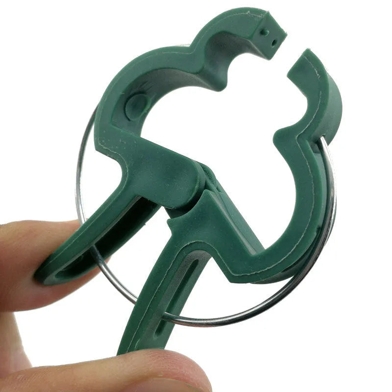 Green plastic plant fixing clips for supporting climbing vegetables like tomatoes and cucumbers