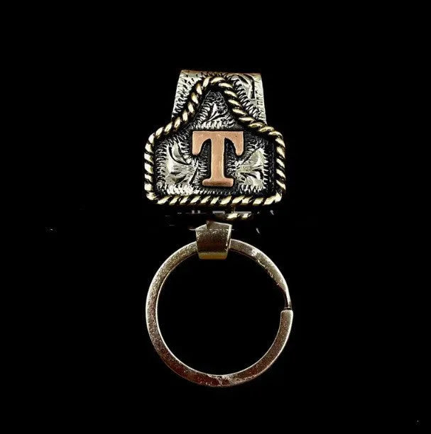 Handmade stainless steel cow tag belt key holder with engraved number plate on a split ring.