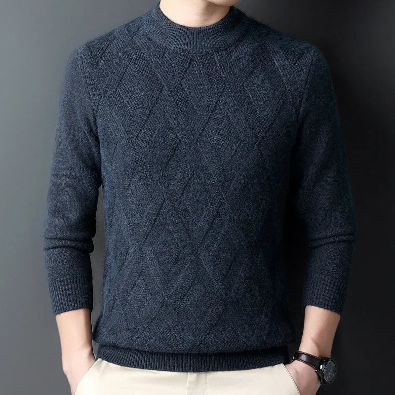 Man wearing a thick grey diamond jacquard knit pullover sweater.