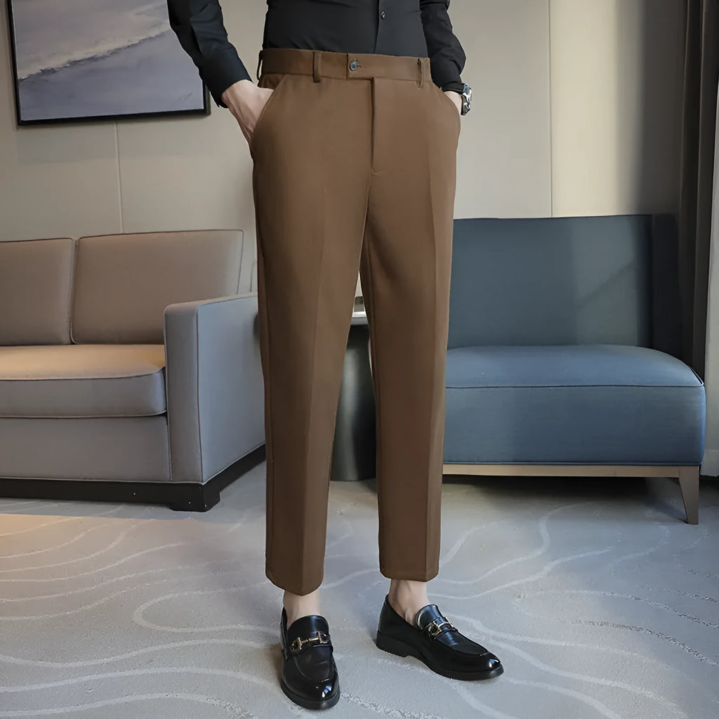 Men's brown straight-leg corduroy trousers with an elasticated waistband laid flat.