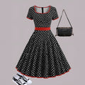 Women's multicolour polka dot pleated dress with square neckline, short sleeves, and front zip.