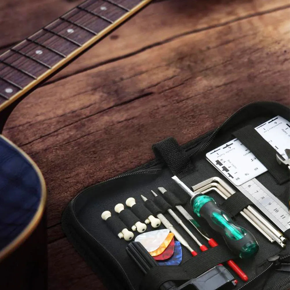 Black guitar repair tool kit open to show plastic and metal maintenance tools for guitar, bass, mandolin, banjo.