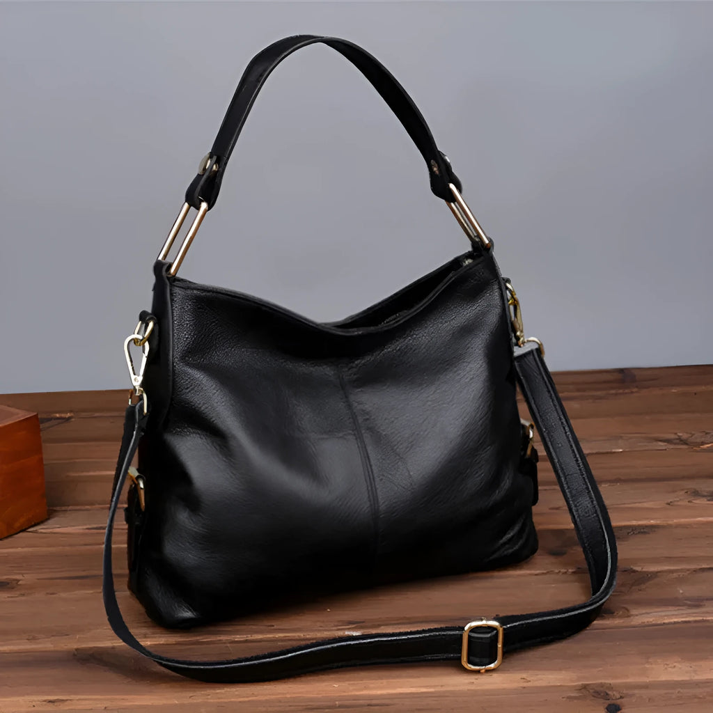 Genuine leather crossbody bag showing vertical square shape and internal compartments for phone and documents