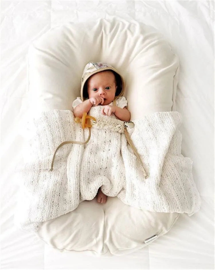 Beige portable cotton baby nest crib cushion measuring 75cm by 45cm for infant sleep.