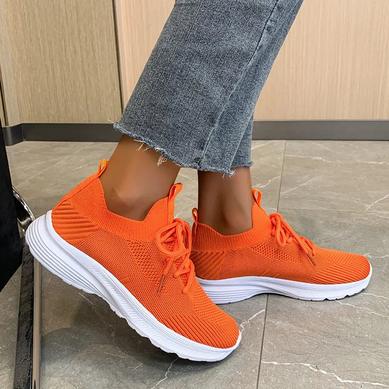 Women's low-top mesh running shoes in creamy white with a rubber sole and round toe.