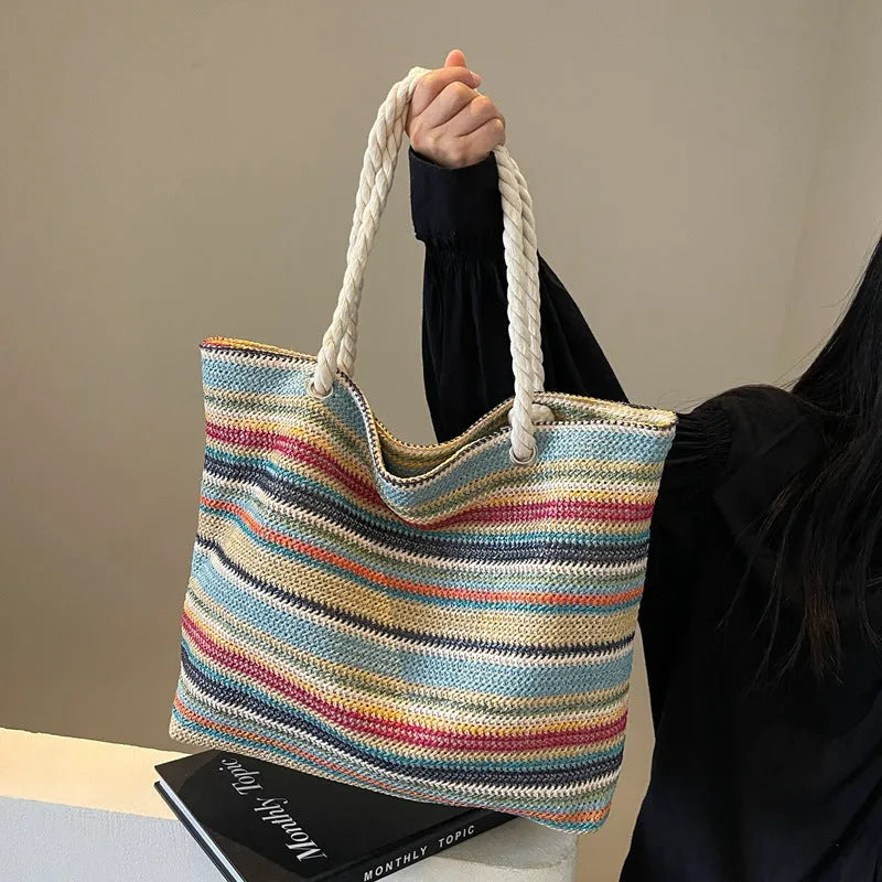 Blue straw woven large capacity single-shoulder bag with nylon construction.