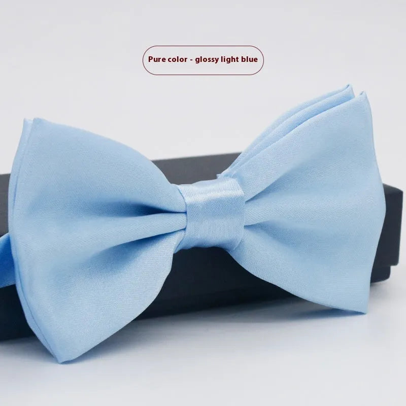 Men's flat head style polyester bow tie in a solid colour, shown with adjustable neck strap.