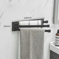 Nordic folding towel bar in black mounted on bathroom wall with towels hanging