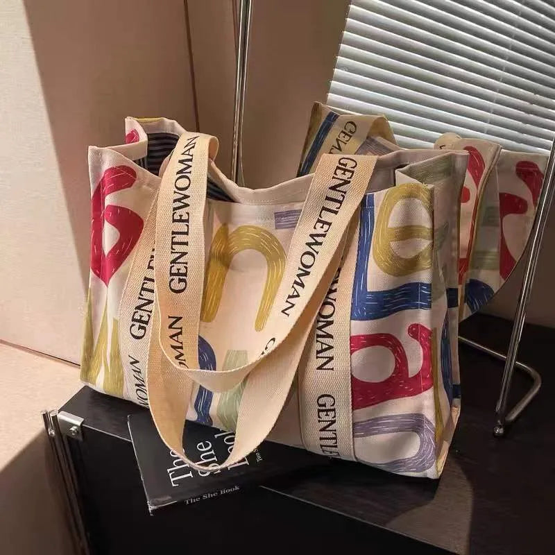 Large canvas tote bag with printed design, shown in multiple colour and pattern options.