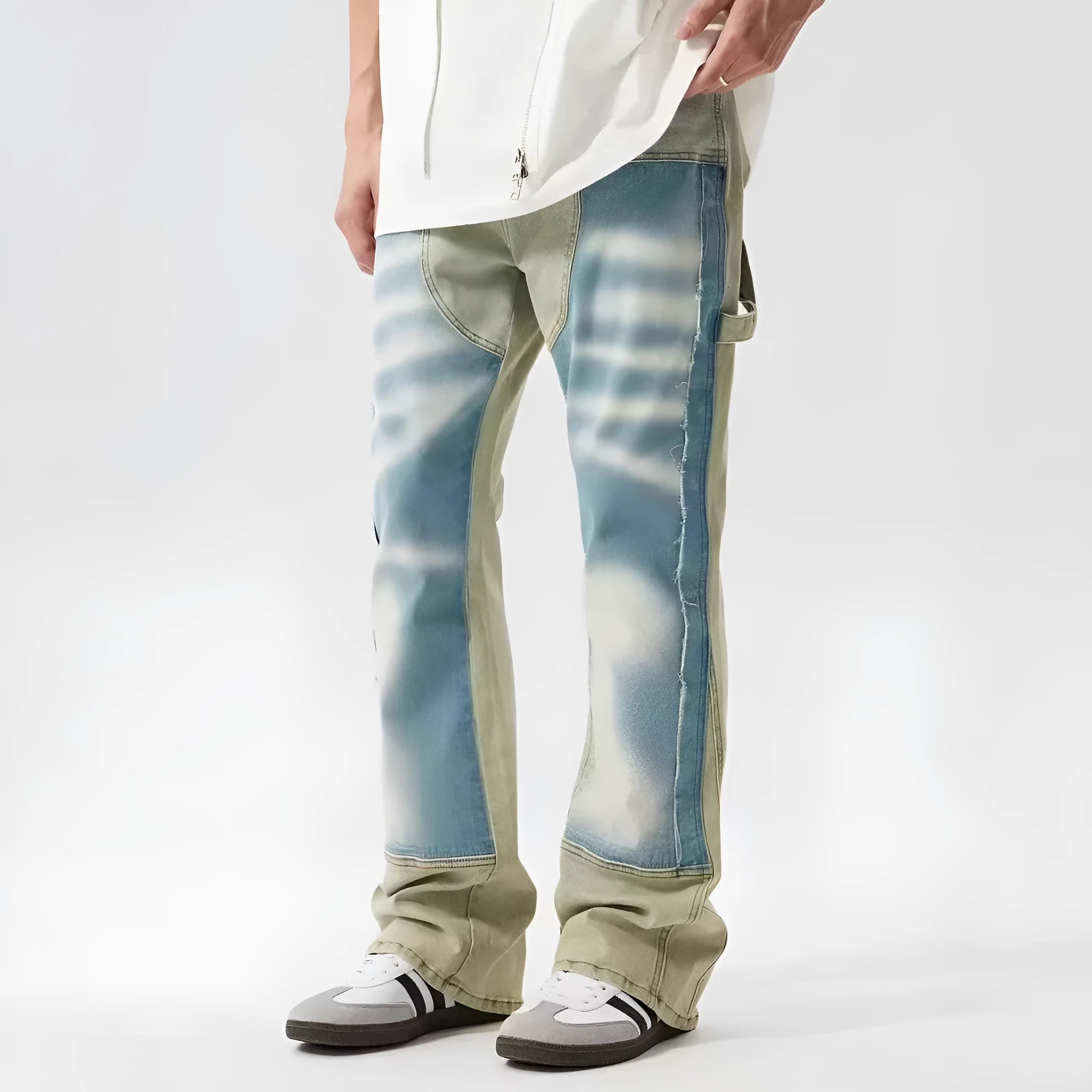 Yellow and blue retro patchwork jeans with splash-ink distressed detailing, showing mid waist and zip fly.
