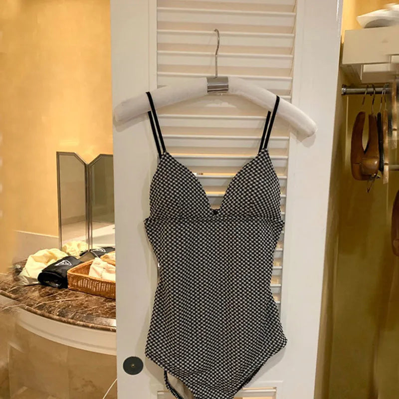 Blue and black one-piece swimsuit for hot springs, designed for belly coverage and smaller chests.