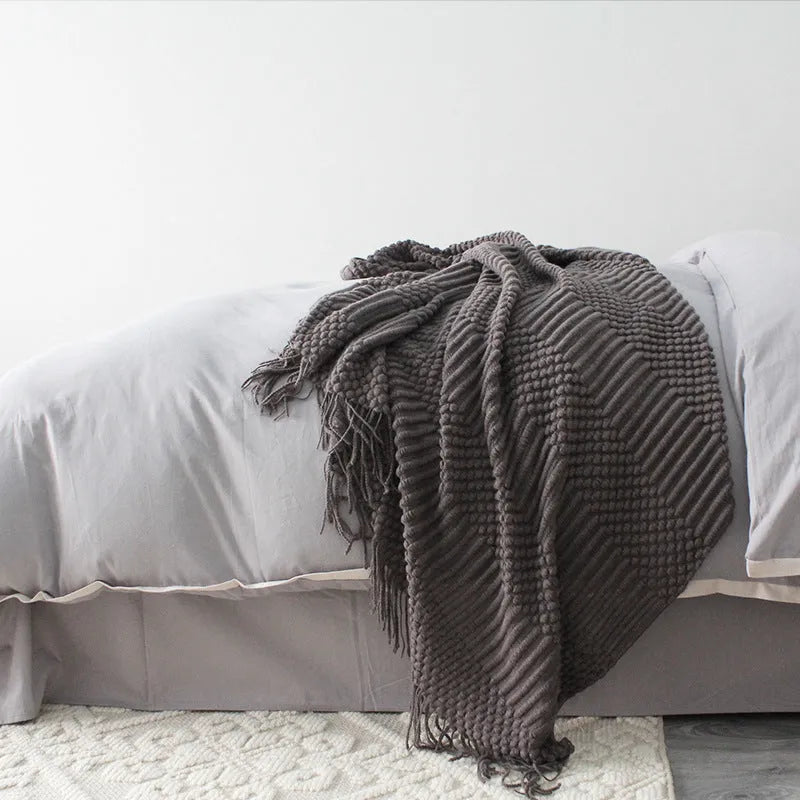 Small light grey polyester nap blanket folded, showing its 127x170cm size.