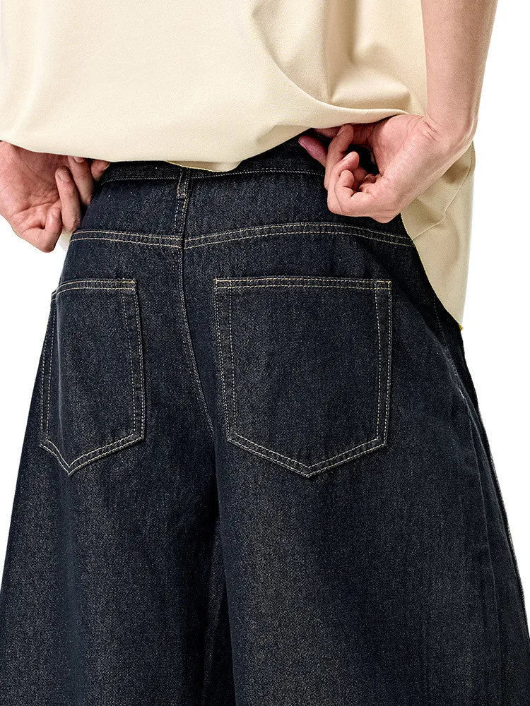 Men's wide leg denim trousers in original cow colour, showing relaxed fit and mid waist design