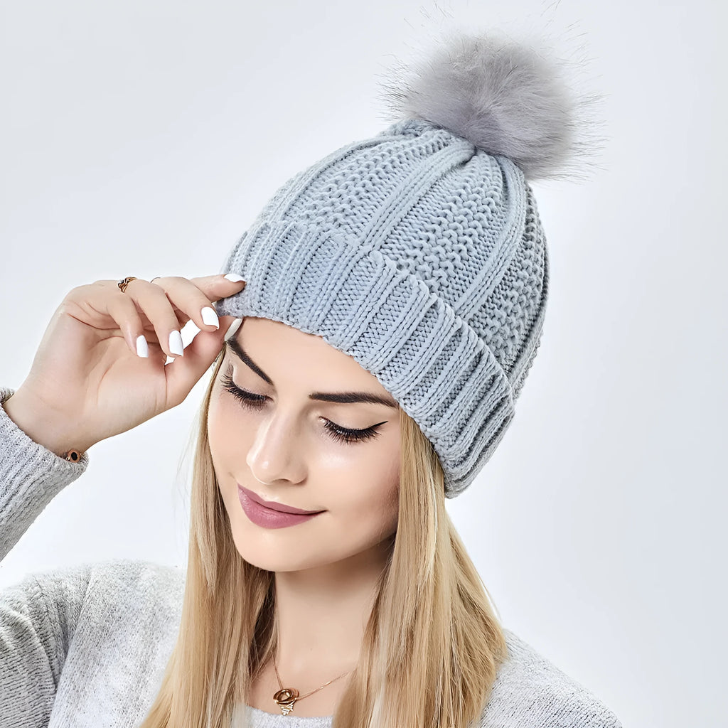 Women's satin lined wool beanie with faux fur pom pom in classic winter colours