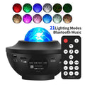 Black starry sky projection lamp with rotating water ripple laser effects on desktop