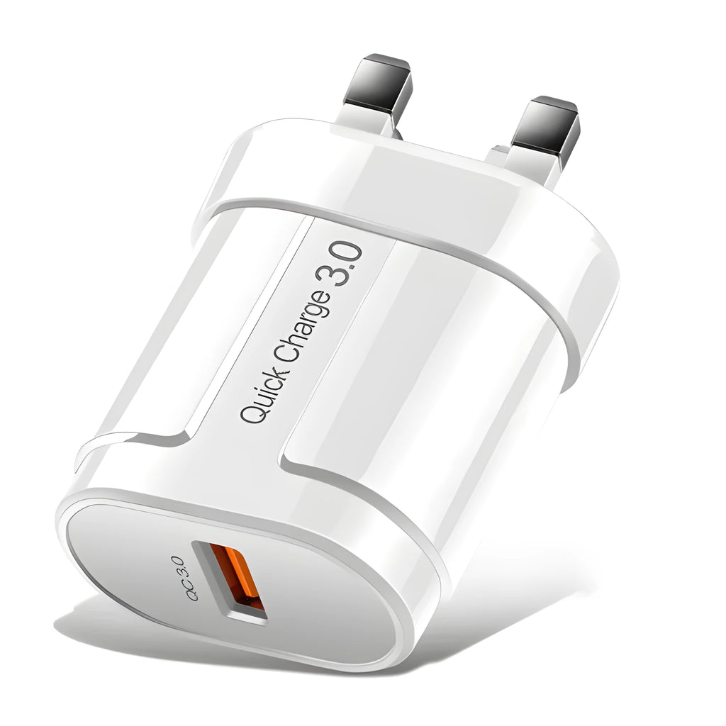 White and black mobile phone travel chargers with UK, US, and EU plug attachments on a table