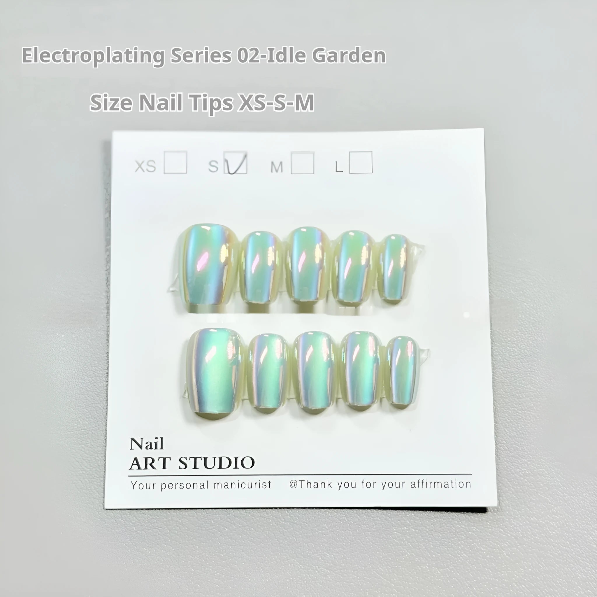 Electroplated Cat's Eye false nail wraps showing Aurora and solid colour designs in short ladder sizes XS, S, and M.