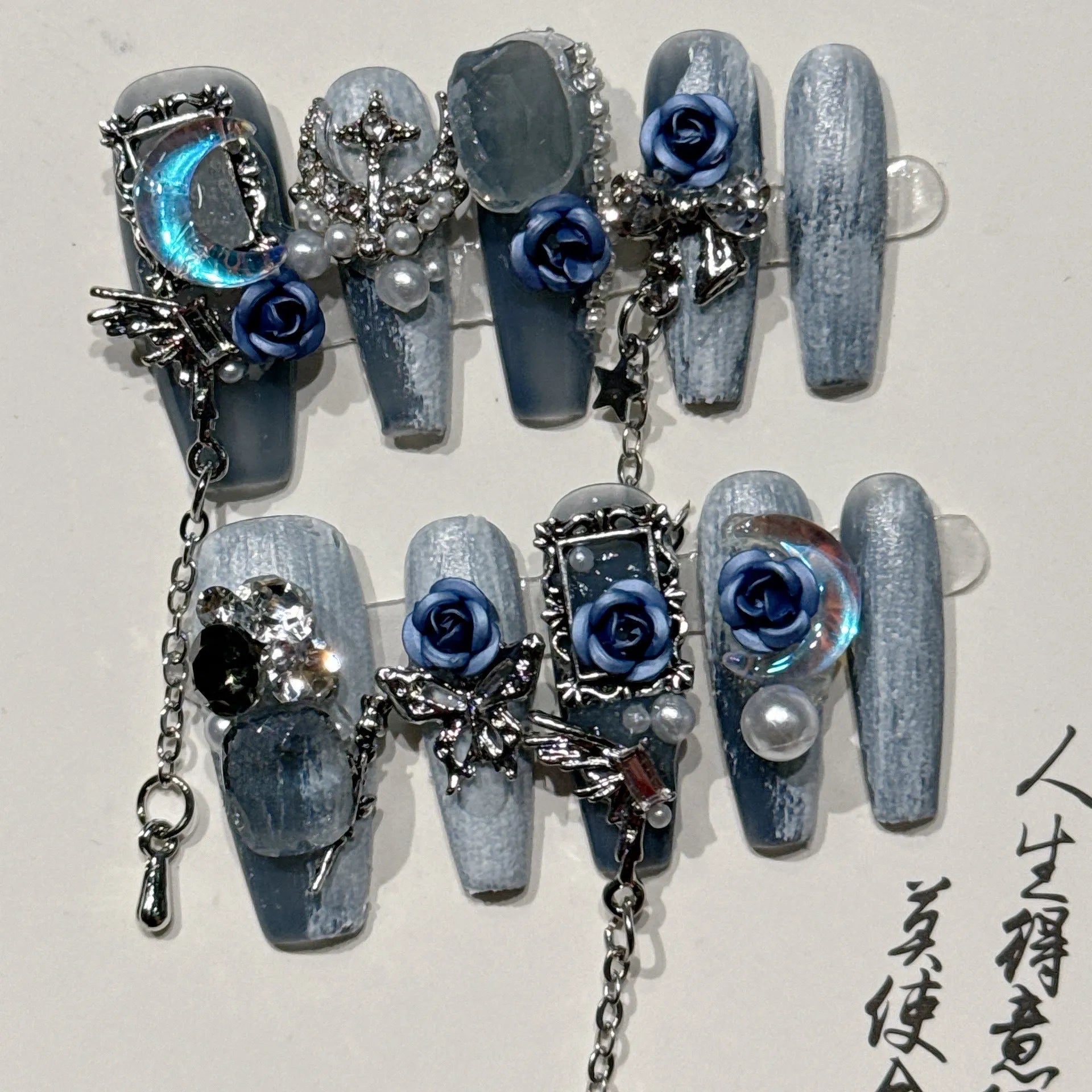 Heavy industry blue evening manicure nails with twinkling rose and flower patterns in four sizes