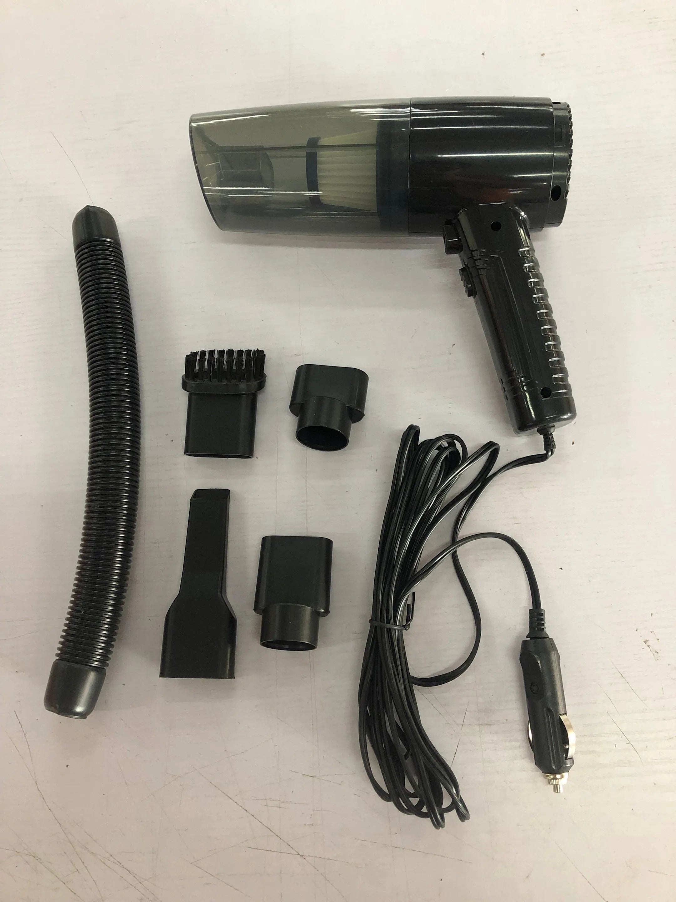 Black portable car vacuum cleaner with accessories for home and automotive use