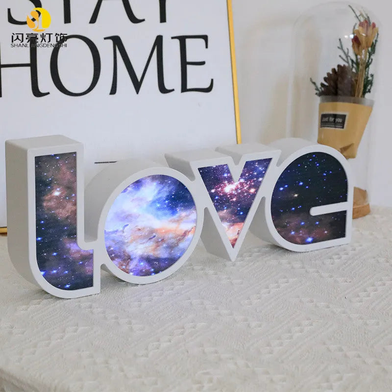Colourful LED love light decorative lamp with plastic shell on a table