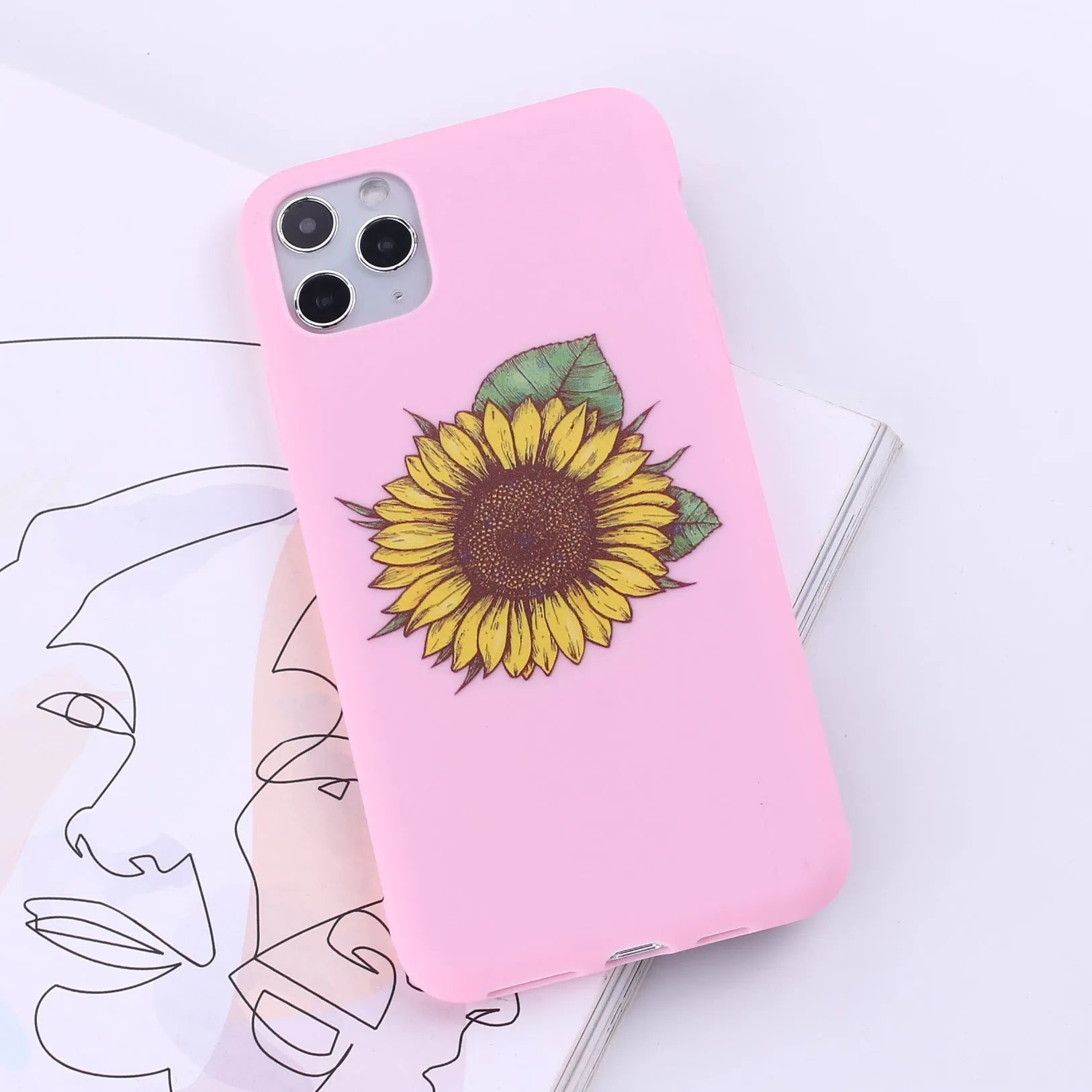Slim TPU mobile phone case for iPhone on a table, showing one of 14 available colour options.