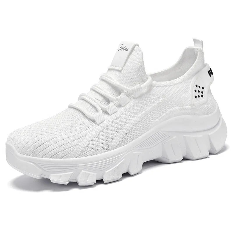 Women's white Flyknit running sneaker with thick PVC sole and lace-up front on a neutral background.