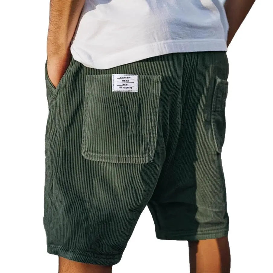 Men's grey corduroy shorts with multiple pockets and straight-leg cut on a neutral background.