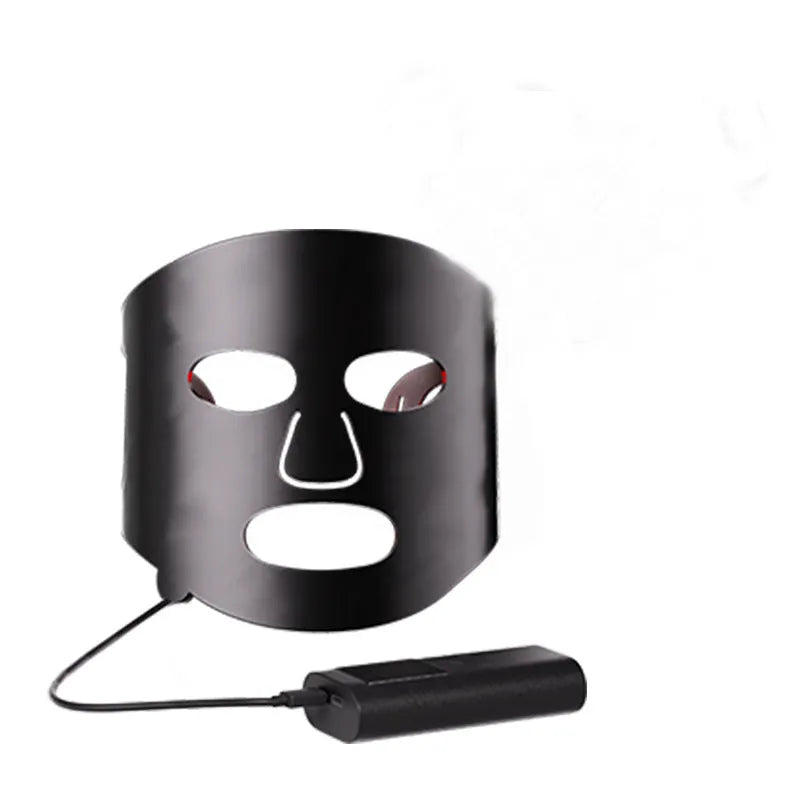 Black and gold LED phototherapy face mask with controller, shown with its USB charging cable.