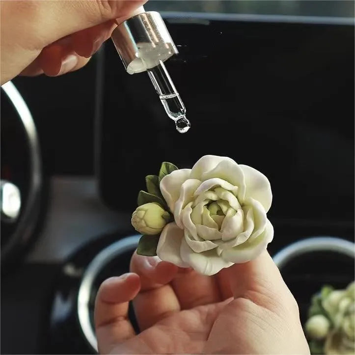 Solid jasmine car perfume for air vent with gypsum base and essential oil bottle in beige white or green.